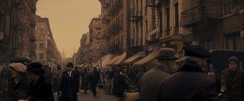 Movie still from “The Immigrant” (2013), directed by James Gray – A crowd of people walking down a street; Wide shot, High angle