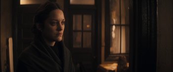 Movie still from “The Immigrant” (2013), directed by James Gray – A woman standing in front of an open window; Close Up shot, Over the shoulder angle
