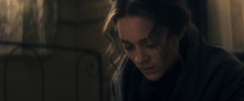 Movie still from “The Immigrant” (2013), directed by James Gray – A woman with long hair is looking down at her face; Close Up shot, Low angle