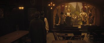 Movie still from “The Immigrant” (2013), directed by James Gray – A group of people standing in front of a mirror; Wide shot, Over the shoulder angle