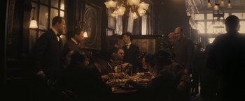 Movie still from “The Immigrant” (2013), directed by James Gray – A group of people sitting around a table; Wide shot, High angle