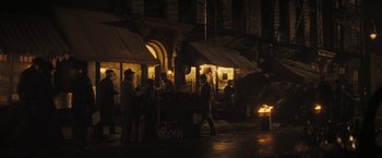 Movie still from “The Immigrant” (2013), directed by James Gray – A group of people walking down a street at night; Wide shot, High angle