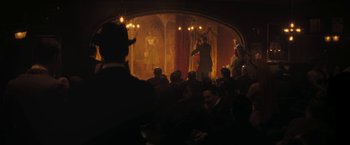 Movie still from “The Immigrant” (2013), directed by James Gray – A group of people sitting in front of a stage; Wide shot, Low angle