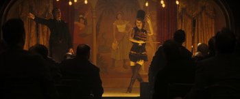 Movie still from “The Immigrant” (2013), directed by James Gray – A woman in a black dress is performing a show; Wide shot, Over the shoulder angle