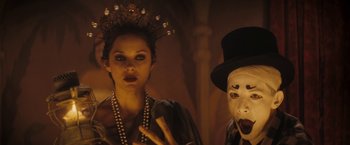 Movie still from “The Immigrant” (2013), directed by James Gray – A woman and a man wearing masks in a dark room; Close Up shot, Low angle
