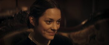Movie still from “The Immigrant” (2013), directed by James Gray – A person smiling at the camera; Close Up shot, Over the shoulder angle