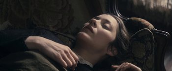 Movie still from “The Immigrant” (2013), directed by James Gray – A woman laying on the ground with her eyes closed; Close Up shot, Overhead angle
