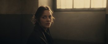 Movie still from “The Immigrant” (2013), directed by James Gray – A woman is sitting in front of a window; Close Up shot, Over the shoulder angle