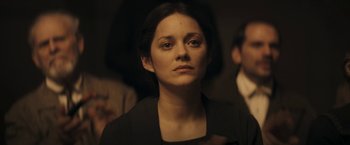 Movie still from “The Immigrant” (2013), directed by James Gray – A person wearing a suit and tie; Close Up shot, Over the shoulder angle