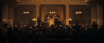 Movie still from “The Immigrant” (2013), directed by James Gray – A group of people sitting in front of an audience; Wide shot, High angle