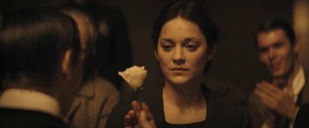 Movie still from “The Immigrant” (2013), directed by James Gray – A woman holding a white rose in her hand; Close Up shot, Over the shoulder angle