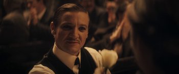 Movie still from “The Immigrant” (2013), directed by James Gray – A person wearing a suit and tie; Close Up shot, Over the shoulder angle