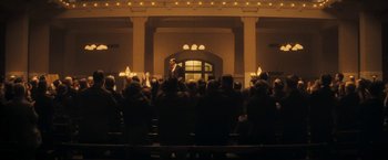 Movie still from “The Immigrant” (2013), directed by James Gray – A group of people sitting in front of an audience; Extreme Wide shot, Low angle