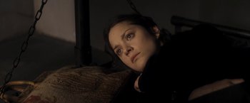 Movie still from “The Immigrant” (2013), directed by James Gray – A woman laying on a couch looking up at the sky; Close Up shot, High angle