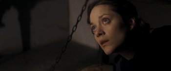 Movie still from “The Immigrant” (2013), directed by James Gray – A person with a chain around their neck; Close Up shot, Low angle
