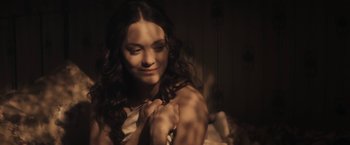Movie still from “The Immigrant” (2013), directed by James Gray – A beautiful young woman with long brown curly hair; Close Up shot, Over the shoulder angle