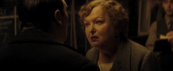 Movie still from “The Immigrant” (2013), directed by James Gray – An older woman looking at a younger man in the mirror; Close Up shot, Over the shoulder angle