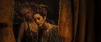 Movie still from “The Immigrant” (2013), directed by James Gray – A group of people standing next to each other wearing pearls; Close Up shot, Over the shoulder angle