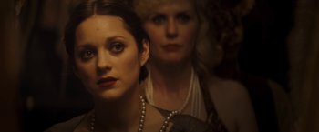 Movie still from “The Immigrant” (2013), directed by James Gray – A woman with pearls and a woman in a white dress; Close Up shot, Over the shoulder angle