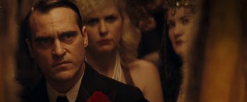 Movie still from “The Immigrant” (2013), directed by James Gray – A man and two women in formal attire; Close Up shot, Over the shoulder angle