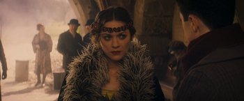 Movie still from “The Immigrant” (2013), directed by James Gray – A person wearing a feather boa; Close Up shot, Over the shoulder angle
