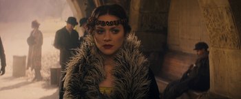 Movie still from “The Immigrant” (2013), directed by James Gray – A person wearing a feather boa; Close Up shot, Over the shoulder angle