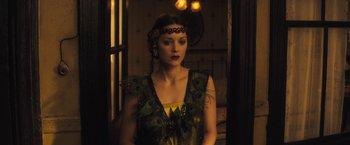 Movie still from “The Immigrant” (2013), directed by James Gray – A woman in a peacock inspired dress; Medium shot, Over the shoulder angle