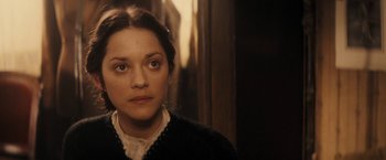 Movie still from “The Immigrant” (2013), directed by James Gray – A young woman in a white shirt and a black sweater; Close Up shot, Over the shoulder angle