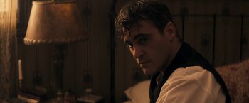 Movie still from “The Immigrant” (2013), directed by James Gray – A person wearing a shirt and tie; Close Up shot, Over the shoulder angle