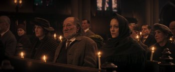 Movie still from “The Immigrant” (2013), directed by James Gray – A man and a woman sitting next to each other in a church; Medium shot, Low angle