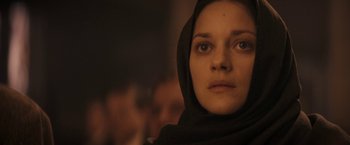Movie still from “The Immigrant” (2013), directed by James Gray – A person wearing a headscarf; Close Up shot, Low angle
