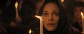 Movie still from “The Immigrant” (2013), directed by James Gray – A woman holding a lit candle in front of her face; Close Up shot, Low angle