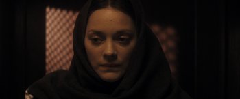 Movie still from “The Immigrant” (2013), directed by James Gray – A woman with a black head covering is looking at the camera; Close Up shot, Low angle