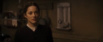 Movie still from “The Immigrant” (2013), directed by James Gray – A woman standing in front of a wall with pans hanging on it; Close Up shot, Over the shoulder angle