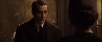 Movie still from “The Immigrant” (2013), directed by James Gray – A man in a suit and a tie; Close Up shot, Over the shoulder angle