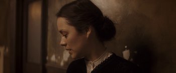 Movie still from “The Immigrant” (2013), directed by James Gray – A woman with a bun is looking to her left; Close Up shot, High angle