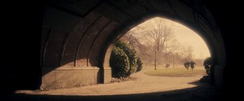 Movie still from “The Immigrant” (2013), directed by James Gray – A view from under an arch of a park; Extreme Wide shot, High angle