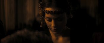 Movie still from “The Immigrant” (2013), directed by James Gray – A young woman wearing an ornate headpiece in the dark; Close Up shot, Over the shoulder angle