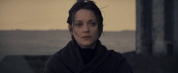 Movie still from “The Immigrant” (2013), directed by James Gray – A person wearing a scarf and looking at the camera; Close Up shot, Over the shoulder angle