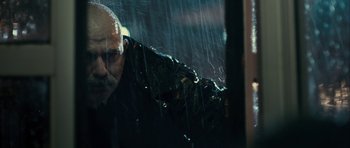 Movie still from “The Imposter” (2012), directed by Bart Layton – A man with a beard is looking out of a car window in the rain; Close Up shot, Low angle