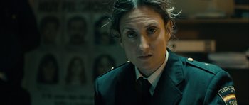 Movie still from “The Imposter” (2012), directed by Bart Layton – A man in a suit and tie looking at the camera; Close Up shot, Over the shoulder angle