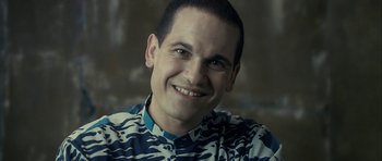 Movie still from “The Imposter” (2012), directed by Bart Layton – A person smiling for the camera; Close Up shot, Over the shoulder angle