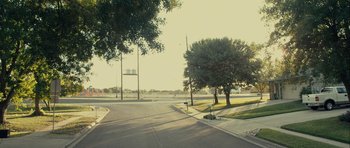 Movie still from “The Imposter” (2012), directed by Bart Layton – A tree is in the middle of the street; Extreme Wide shot, Low angle