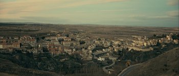 Movie still from “The Imposter” (2012), directed by Bart Layton – An aerial view of a town with a lot of buildings; Extreme Wide shot, High angle