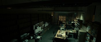 Movie still from “The Imposter” (2012), directed by Bart Layton – A room filled with lots of books and papers on a desk; Wide shot, High angle