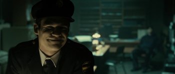 Movie still from “The Imposter” (2012), directed by Bart Layton – A man wearing a uniform is smiling for the camera; Close Up shot, Low angle