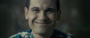 Movie still from “The Imposter” (2012), directed by Bart Layton – A man smiling for the camera; Close Up shot, Low angle