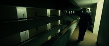 Movie still from “The Imposter” (2012), directed by Bart Layton – A dark room with a reflection of a building; Extreme Wide shot, High angle
