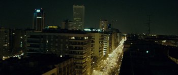 Movie still from “The Imposter” (2012), directed by Bart Layton – A view of a city at night from above; Extreme Wide shot, High angle