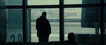 Movie still from “The Imposter” (2012), directed by Bart Layton – A man standing in front of an open window; Wide shot, Over the shoulder angle